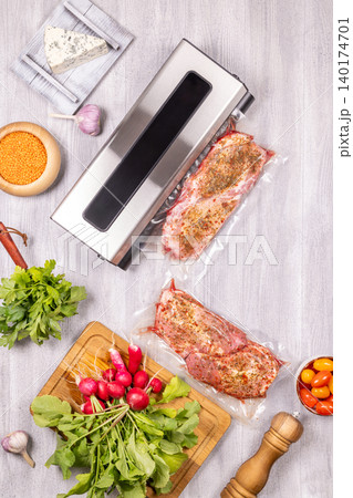 Vacuum sealer packaging meat for sous vide cooking Vacuum sealer packaging meat for sous vide cooking 140174701