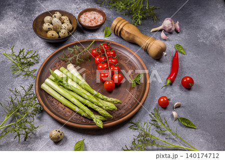 Fresh green asparagus, cherry tomatoes, and quail eggs on plate Fresh green asparagus, cherry tomatoes, and quail eggs on plate 140174712