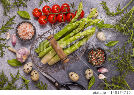 Fresh asparagus, cherry tomatoes, and quail eggs preparing spring meal 140174716