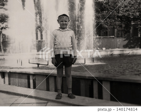 Young boy standing beside a fountain during a family trip in Crimea in 1971 140174814