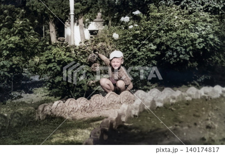 Young boy beside a decorative garden pond during a family trip in Crimea in 1971 140174817