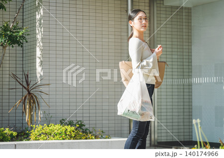 お買い物から自宅のマンションへ帰る若い女性 お買い物から自宅のマンションへ帰る若い女性 140174966