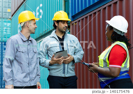 Multinational logistics workers discussing shipment operations at container yard, using digital tablet for cargo management, teamwork, industrial communication and global supply chain coordination Multinational logistics workers discussing shipment operations at container yard, using digital tablet for cargo management, teamwork, industrial communication and global supply chain coordination 140175476