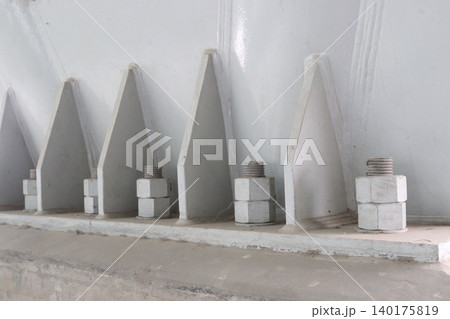The image features large, thick anchor bolts The image features large, thick anchor bolts 140175819