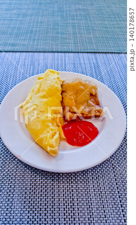 close up photo of omelette snack, fried tempeh and sauce 140178657