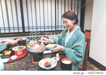 温泉旅館で会席料理を食べる浴衣姿の女性 温泉旅館で会席料理を食べる浴衣姿の女性 140179458