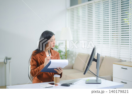 Confident business expert attractive smiling young woman typing laptop and holding digital tablet Confident business expert attractive smiling young woman typing laptop and holding digital tablet 140179821