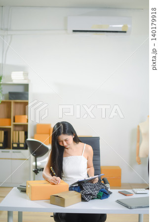 Young Asian women selling clothes on video streaming.Startup small business SME, using smartphone or tablet 140179918