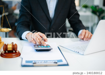 justice and law concept.businessman or lawyer or accountant working on accounts using a smart phone laptop digital tablet calculator justice and law concept.businessman or lawyer or accountant working on accounts using a smart phone laptop digital tablet calculator 140180012