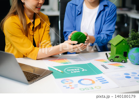 Business team meeting for ESG, net zero, and sustainability goals. Green energy, climate action, and eco-friendly strategies Business team meeting for ESG, net zero, and sustainability goals. Green energy, climate action, and eco-friendly strategies 140180179