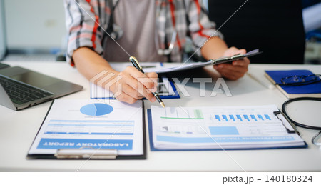Medical technology concept. Doctor working with mobile phone and stethoscope and digital tablet laptop in modern office Medical technology concept. Doctor working with mobile phone and stethoscope and digital tablet laptop in modern office 140180324