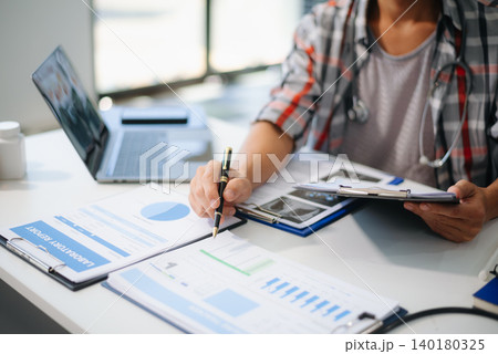 Medical technology concept. Doctor working with mobile phone and stethoscope and digital tablet laptop in modern office Medical technology concept. Doctor working with mobile phone and stethoscope and digital tablet laptop in modern office 140180325