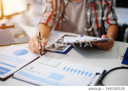 Medical technology concept. Doctor working with mobile phone and stethoscope and digital tablet laptop in modern office Medical technology concept. Doctor working with mobile phone and stethoscope and digital tablet laptop in modern office 140180326