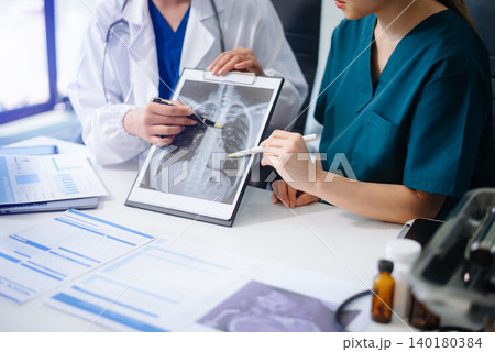 Medical team of doctors and a nurse using laptops in hospital office. Collaboration, diagnosis, and modern technology meet Medical team of doctors and a nurse using laptops in hospital office. Collaboration, diagnosis, and modern technology meet 140180384