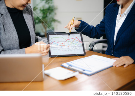 Business team collaboration discussing working analyzing with financial data and marketing growth report graph in team, presentation and digital tablet, laptop. 140180580