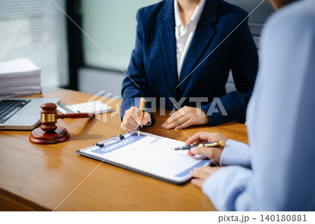 Business and lawyers discussing contract papers with brass scale on desk in office. Law, legal services, advice, justice and law concept 140180881