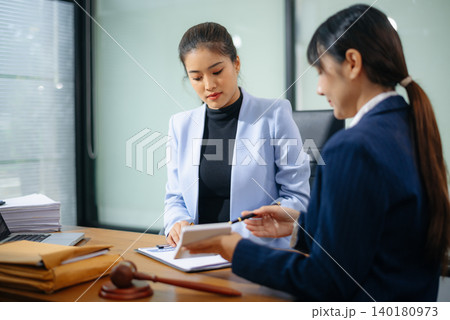 Professional female lawyers consulting on legal cases in a modern office. Perfect for law, business, justice 140180973