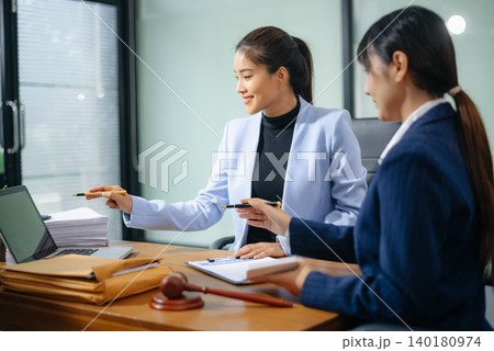Professional female lawyers consulting on legal cases in a modern office. Perfect for law, business, justice 140180974