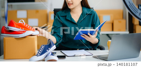 Businesswoman preparing product shipments. Highlighting creativity, entrepreneurship, and the small business journey Businesswoman preparing product shipments. Highlighting creativity, entrepreneurship, and the small business journey 140181107