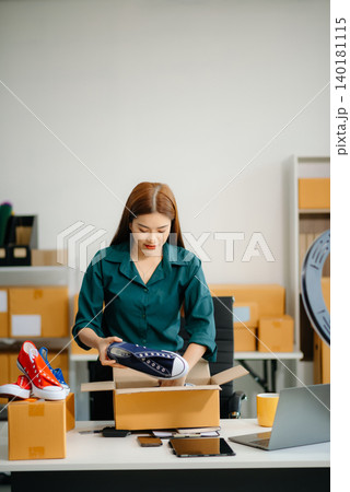 Businesswoman preparing product shipments. Highlighting creativity, entrepreneurship, and the small business journey Businesswoman preparing product shipments. Highlighting creativity, entrepreneurship, and the small business journey 140181115