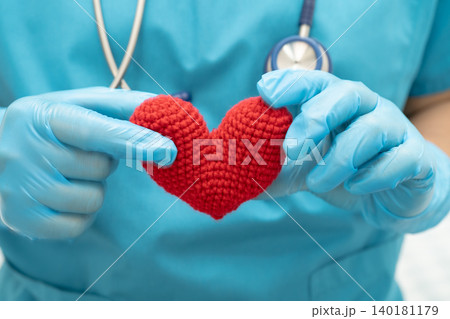 Doctor holding a red heart in hospital ward, healthy strong medical. Doctor holding a red heart in hospital ward, healthy strong medical. 140181179