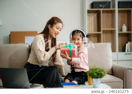 A caring mother and young daughter share a bonding moment doing homework at home. A caring mother and young daughter share a bonding moment doing homework at home. 140181273