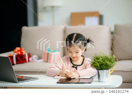 A caring mother and young daughter share a bonding moment doing homework at home. A caring mother and young daughter share a bonding moment doing homework at home. 140181274