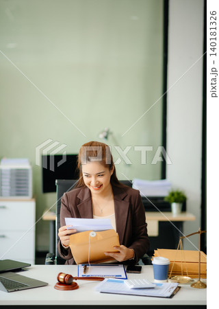 Asian Female judge in a courtroom on white table and Counselor or Male lawyer working in office. 140181326