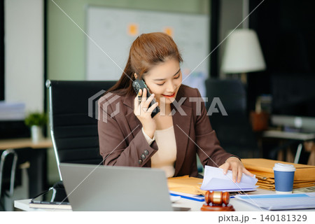 Asian Female judge in a courtroom on white table and Counselor or Male lawyer working in office. 140181329