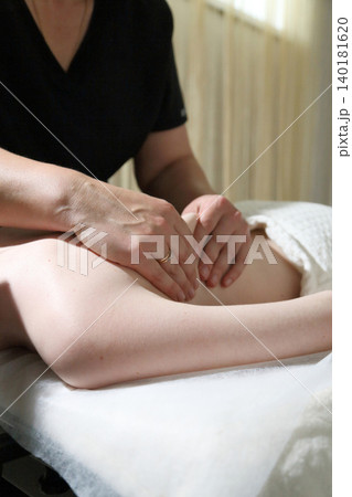 SPA salon and massage. Massage room. A massage therapist is working with a young woman.  140181620