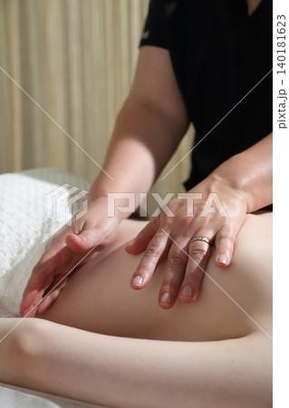 SPA salon and massage. Massage room. A massage therapist is working with a young woman. SPA salon and massage. Massage room. A massage therapist is working with a young woman. 140181623