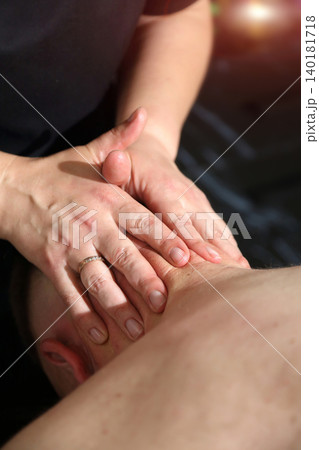 SPA salon. Massage room. A massage therapist is working with a man. Massage parlor. SPA salon. Massage room. A massage therapist is working with a man. Massage parlor. 140181718