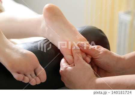 Kyiv, Ukraine - June 2, 2026: SPA salon. Beauty salon and massage. Massage room. A massage therapist is working with a young woman. Hand massage. 140181724