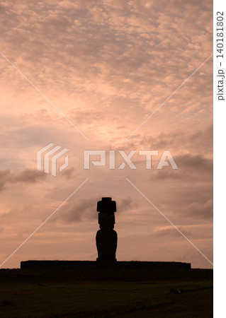 Serene moai statue silhouette facing sunset on easter island chile Serene moai statue silhouette facing sunset on easter island chile 140181802