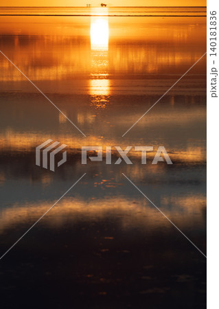 Tranquil sunset reflection on water of Salar de Uyuni in Bolivia Tranquil sunset reflection on water of Salar de Uyuni in Bolivia 140181836