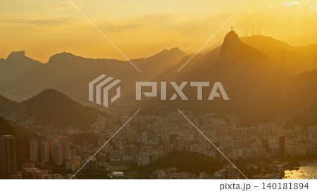 Serene golden sunset illuminates beautiful mountain and cityscape landscape of Rio de Janeiro Brazil Serene golden sunset illuminates beautiful mountain and cityscape landscape of Rio de Janeiro Brazil 140181894
