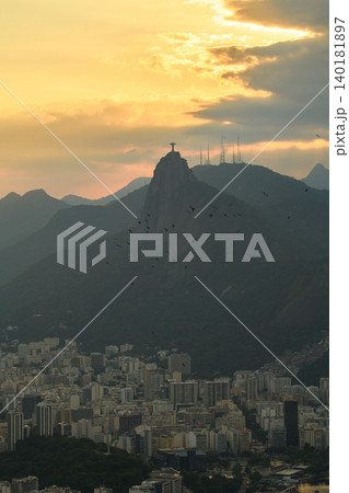 Serene sunset silhouette view of Christ Redeemer statue on Corcovado mountain overlooking Rio de Janeiro Brazil cityscape Serene sunset silhouette view of Christ Redeemer statue on Corcovado mountain overlooking Rio de Janeiro Brazil cityscape 140181897