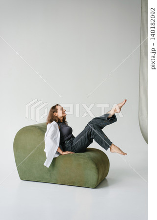Happy Woman Sitting Green Sofa Legs Up 140182092