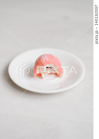 Bitten Pink Mochi Dessert with Cream and Fruit Filling 140182097