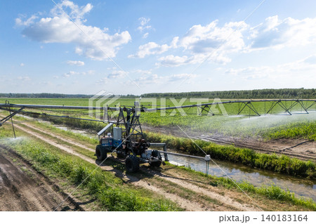 Autonomous machine is moving watering pivot along irrigation canal Autonomous machine is moving watering pivot along irrigation canal 140183164