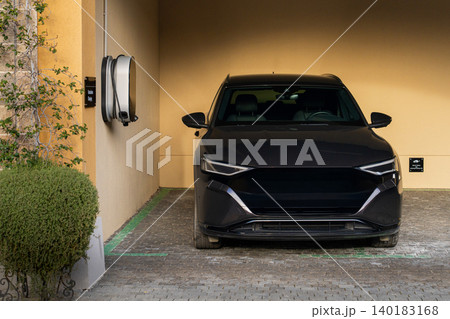 Electric SUV next to charging station Electric SUV next to charging station 140183168