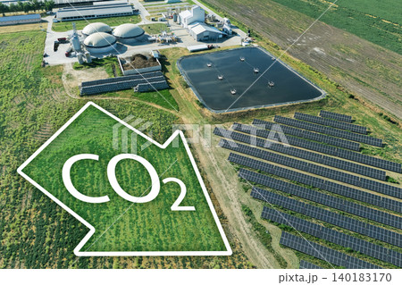 Biogas plant with CO2 emission reduction symbol. Decarbonization and carbon neutrality concept. 140183170