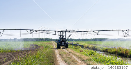 Autonomous machine is moving watering pivot along irrigation canal. 140183197