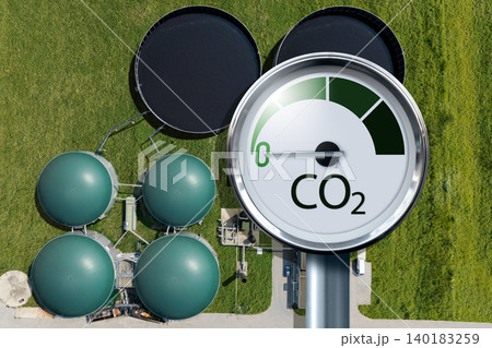 Biogas plant with CO2 emission reduction symbol. Decarbonization and carbon neutrality concept. 140183259