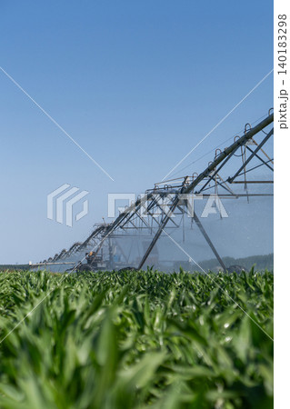 Autonomous machine is moving watering pivot along irrigation canal. Autonomous machine is moving watering pivot along irrigation canal. 140183298