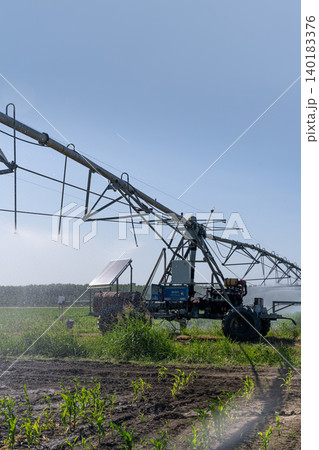 Autonomous machine is moving watering pivot along irrigation canal. Autonomous machine is moving watering pivot along irrigation canal. 140183376