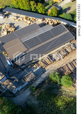 Aerial view of a sawmill factory uses renewable solar energy, with stacks of processed lumber and timber Aerial view of a sawmill factory uses renewable solar energy, with stacks of processed lumber and timber 140183381