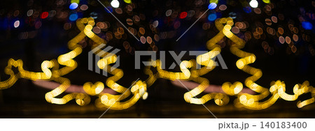 Blurred holiday background with bokeh. Defocused New Year and Christmas illumination. Blurred holiday background with bokeh. Defocused New Year and Christmas illumination. 140183400