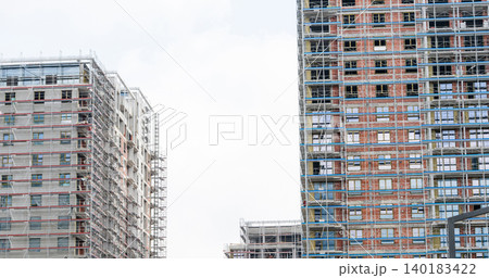 Construction of a building using scaffolding. Construction of a building using scaffolding. 140183422