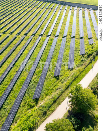 Aerial view of solar power station on a green field. Sustainable development. Aerial view of solar power station on a green field. Sustainable development. 140183650
